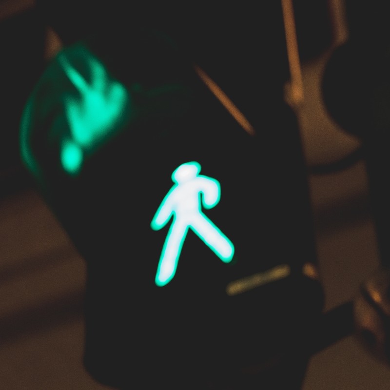 Green walk sign at a traffic intersection