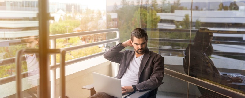 Man working on laptop outdoors
