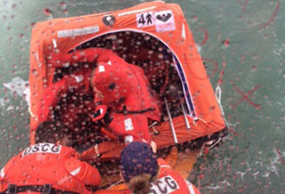 Crewmembers from the Last Stand are transferred from their life raft onto a Coast Guard response boat after a collision with the tug Dean Reinauer. USCG photo.