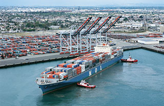 Tugs maneuver a containership at the Port of Los Angeles. Port of Los Angeles photo.