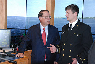 Morton S. Bouchard III with SUNY Maritime cadet Kelly Paseka on bridge of tug and barge simulator. Kirk Moore photo.
