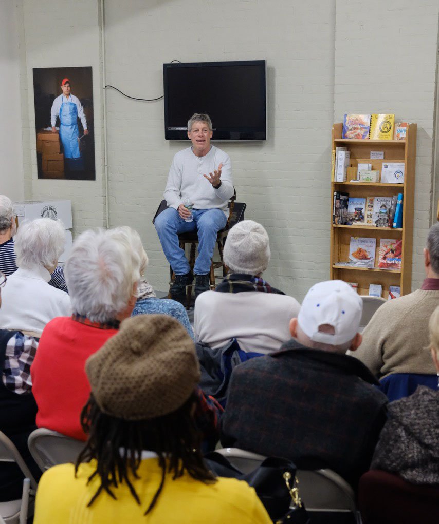 Veteran scallop boat captain Chris Wright draws a crowd at the New Bedford Fishing Heritage Center on Jan. 11. JP Vellotti photo.