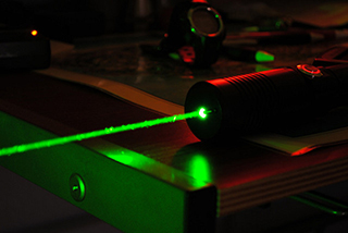 A high-power green laser. Creative Commons photo by Andrew &quot;FastLizard4&quot; Adams.