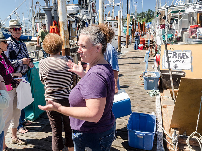 Ruby Moon shows a group around the commercial fishing docks in Newport, Ore., as part of the Oregon Sea Grant 
