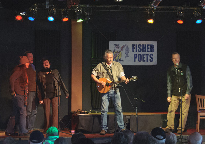 Jon Campbell performs at FisherPoets with his impromptu backups: Moe Bowstern, Dano Quinn, Dinah Urell and Jay Speakman. Patrick Dixon photo.