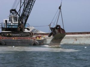 Limestone being deployed by barge on an inshore artificial reef site. Louisiana Department of Wildlife and Fisheries photo.