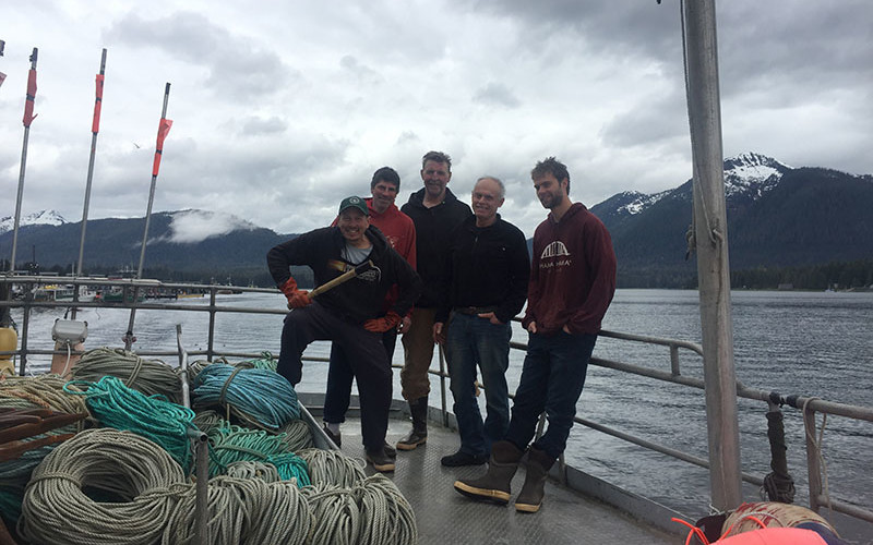 The crew of the F/V Discovery (L-R: Capt. JD, Matt Marinchovich, Big George, Mike Carr, and son Rich Carr) making their final halibut delivery in Petersburg, Alaska, before heading home to Port Townsend, Wash.