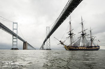 A replica of the historic French frigate Hermione sails under the Chesapeake Bay Bridge. Jay Fleming photo.