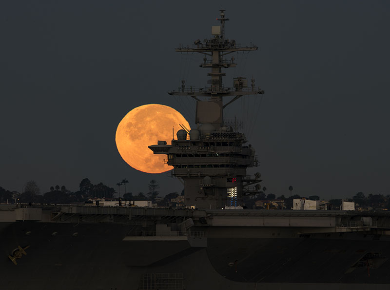 Supermoon sets behind USS Theodore Roosevelt (CVN 71)
