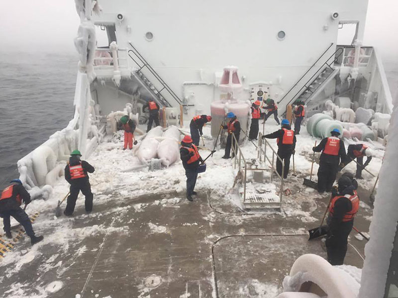 Crew of CGC Alder clears ice from deck