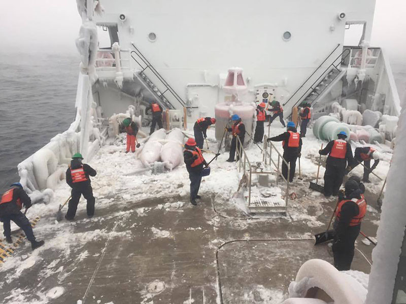 Crew of CGC Alder clears ice from deck