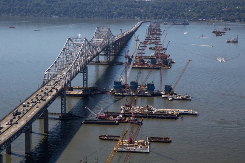 The new bridge's main span towers begin to rise.